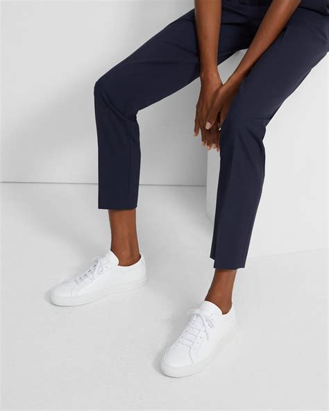 woman by common projects sneakers.